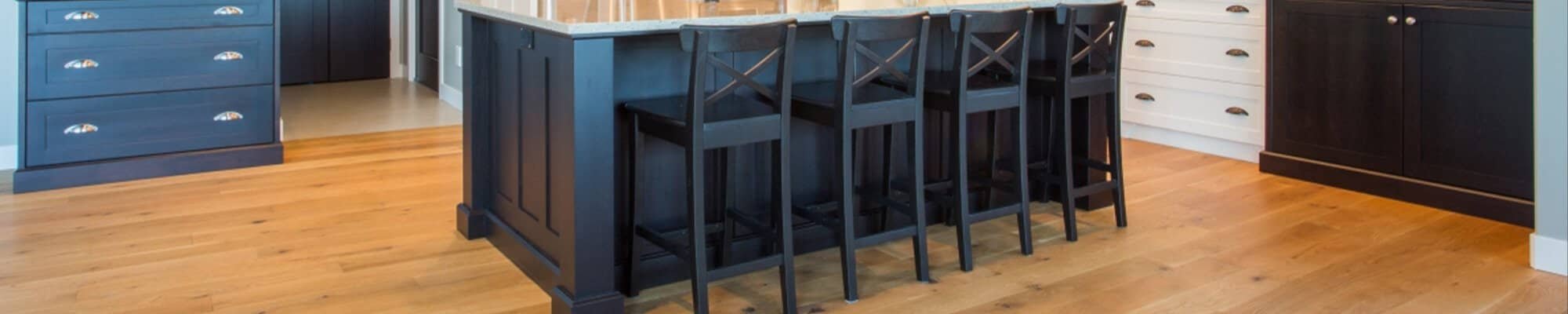 Hardwood Flooring in a traditional kitchen with black cabinets